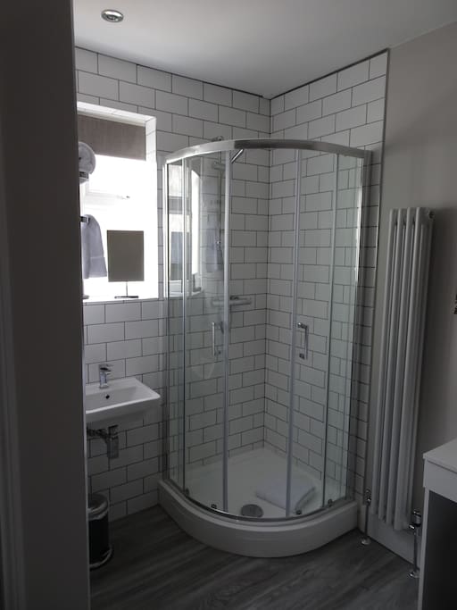 The shower and sink are part of you room, with your own private toilet housed in its own area.