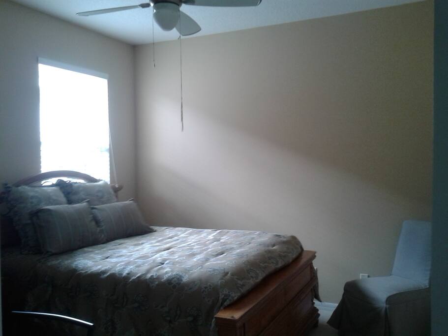 Bedroom 1: queen bed with work station and sitting chair.