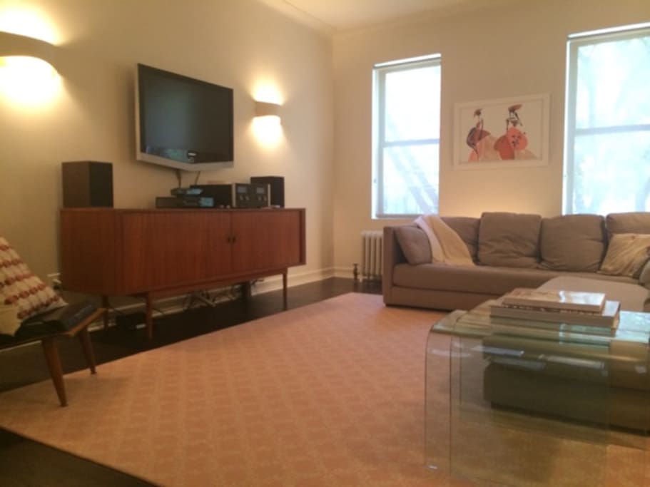 The large living room with big, comfy couches, is located adjacent to dining room
