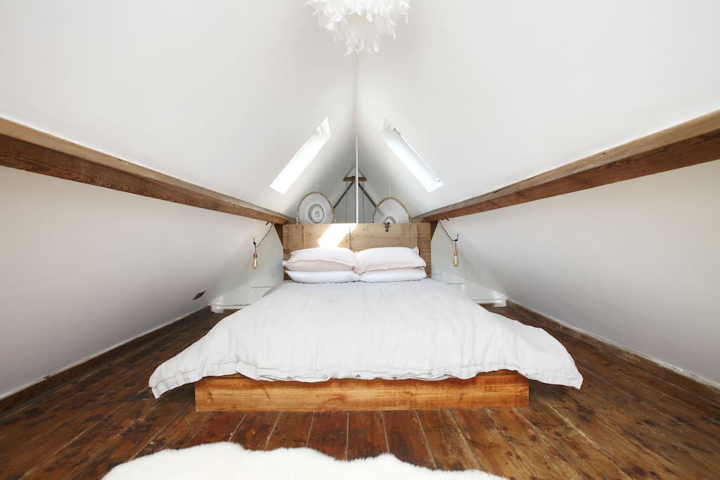 Up the original hayloft ladder to your king sized bed
