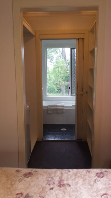 Walk through robes to bathroom and spa