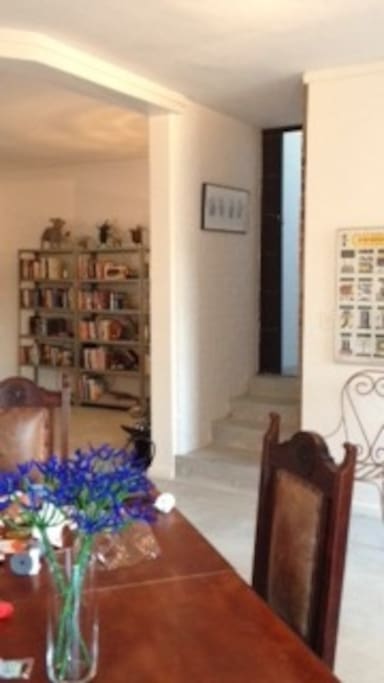 Stairs leading up to two bedrooms and two bathrooms, with additional security gate on landing