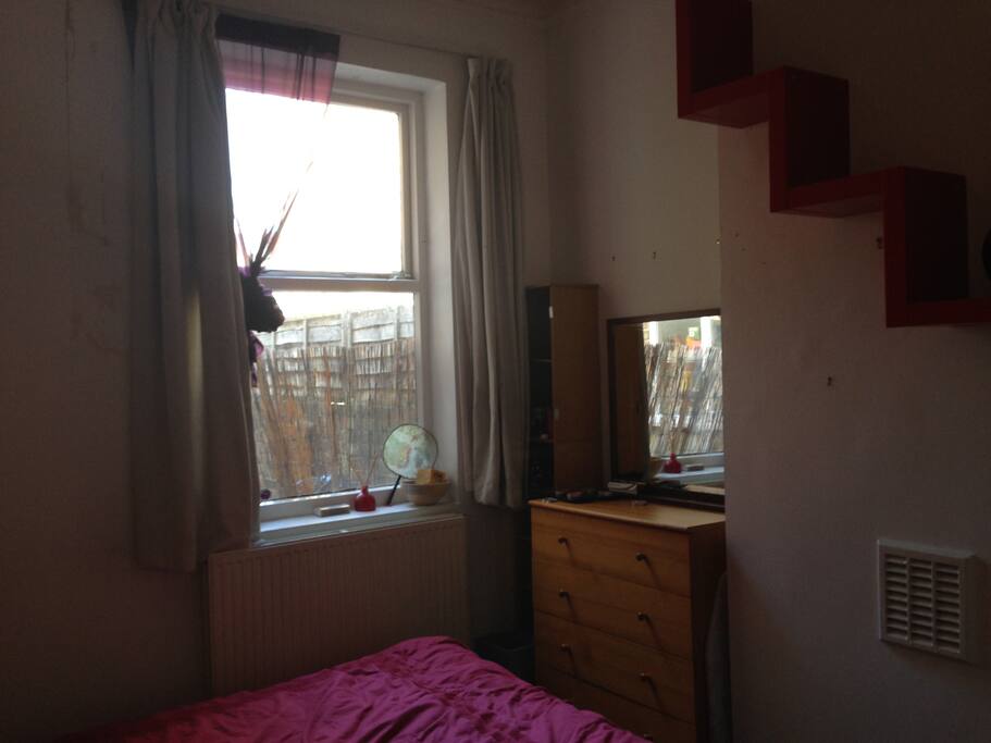 Bedroom bookshelf and chest of drawers and windows
