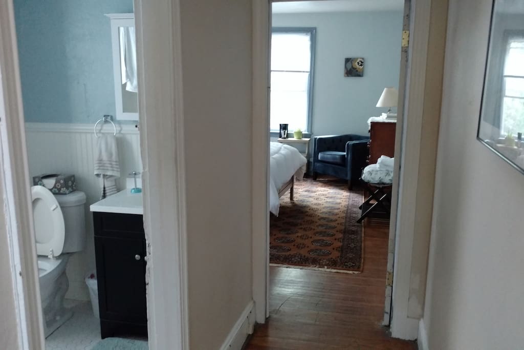 Hallway with view into room and bathroom
