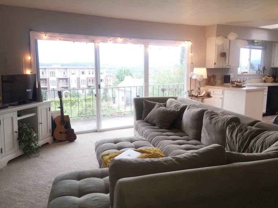 In the natural light filled living room, we have out very spacious, extremely comfortable microfiber sectional that can easily fit two people. I've fallen asleep on it myself far too many times to count. :) The following pictures of Mt. Hood were taken standing from where the ottoman is pictured.