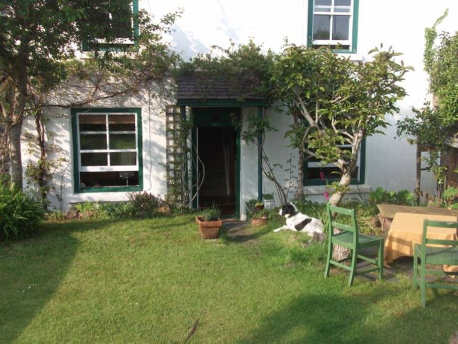 Front of main part of cottage with raised south-facing walled garden