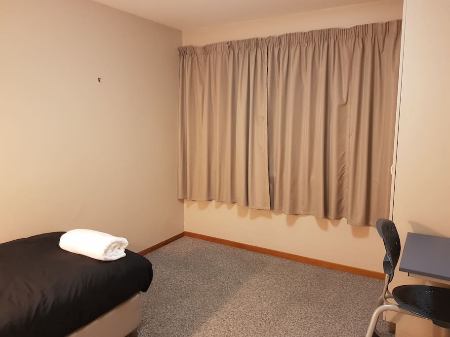 Room with a single bed and desk