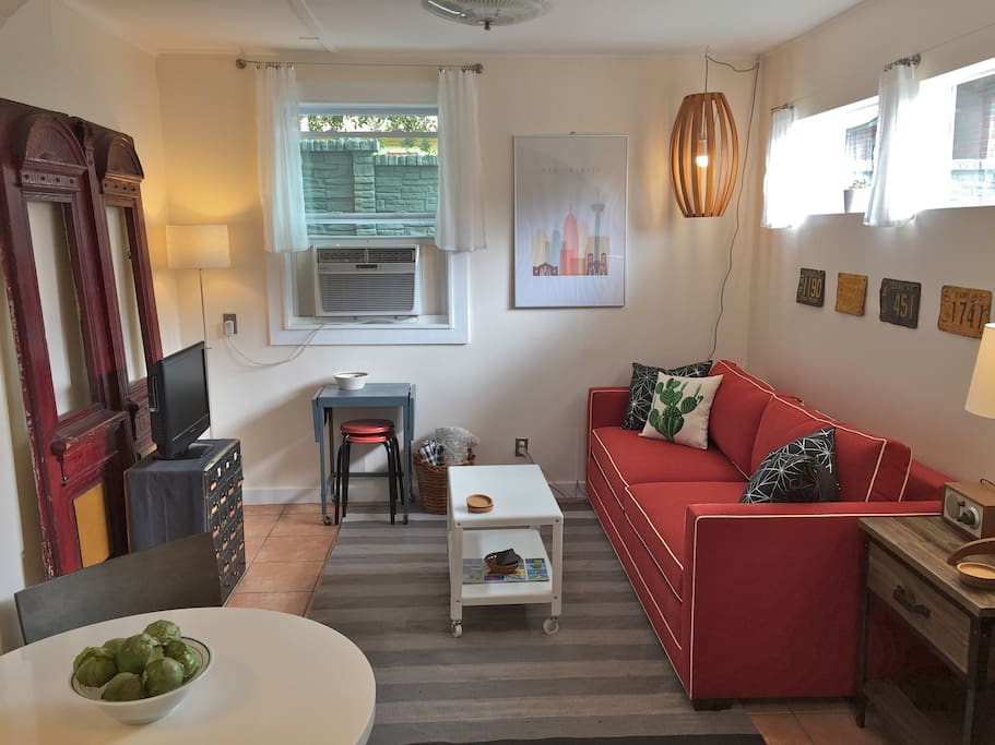 The living room, with a queen-sized, Crate & Barrel sleeper sofa (that tilts up for TV watching, reading, or working in bed).