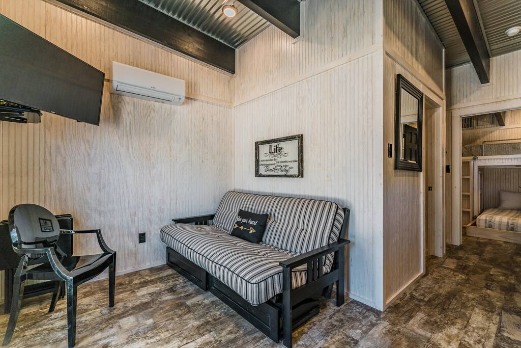 Living space with flat screen TV + Cable, AC/Heat unit. Couch folds into full.
