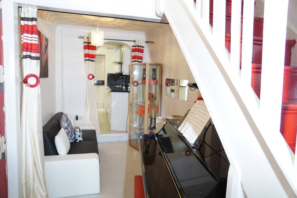 Lounge with grand piano & a single sofa bed