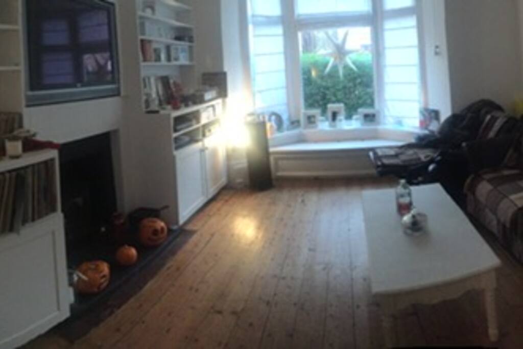 Living room with wood burner and cable tv & DVD player and music equipment