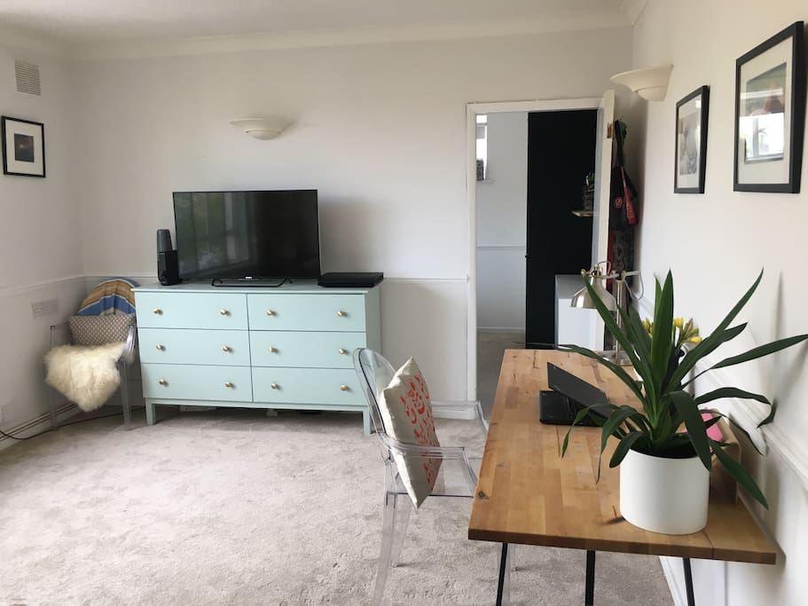 Living room. Virgin TV and desk area for working if needed.