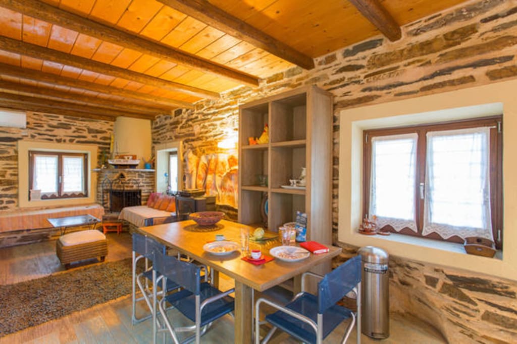 Dinning area and living room (by the fireplace you can see the 2 out of 3 sofas where 3 more persons could sleep)