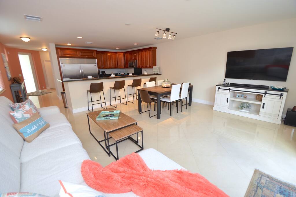 Spacious Open Living Area Features Leather Sectional Sofa + Dining + LED HD TV + Direct Pool Lounge Access...