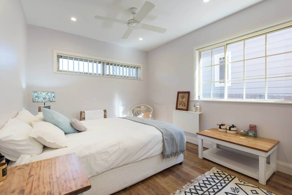 Studio with bedroom and coffee table and chairs for simple dining in.
