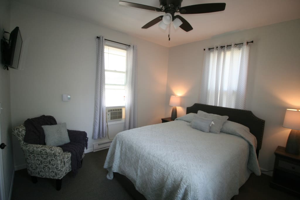 Queen size bed with chair, nightstand AC and TV