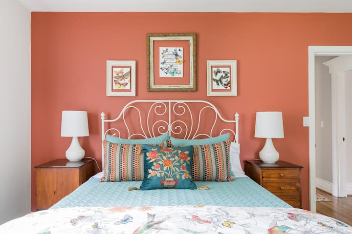 The lovely "Butterfly Bedroom" on the main floor charms everyone.  The painted feature wall is actually a more subdued rust color than shown in this picture; our goal is to give you a calm and beautiful getaway!