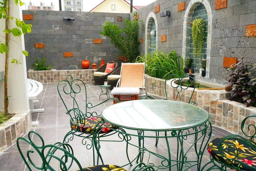 Terrace in the 1st floor where you can sit to enjoy your drink or take a sunbath with many flowers are blooming around 