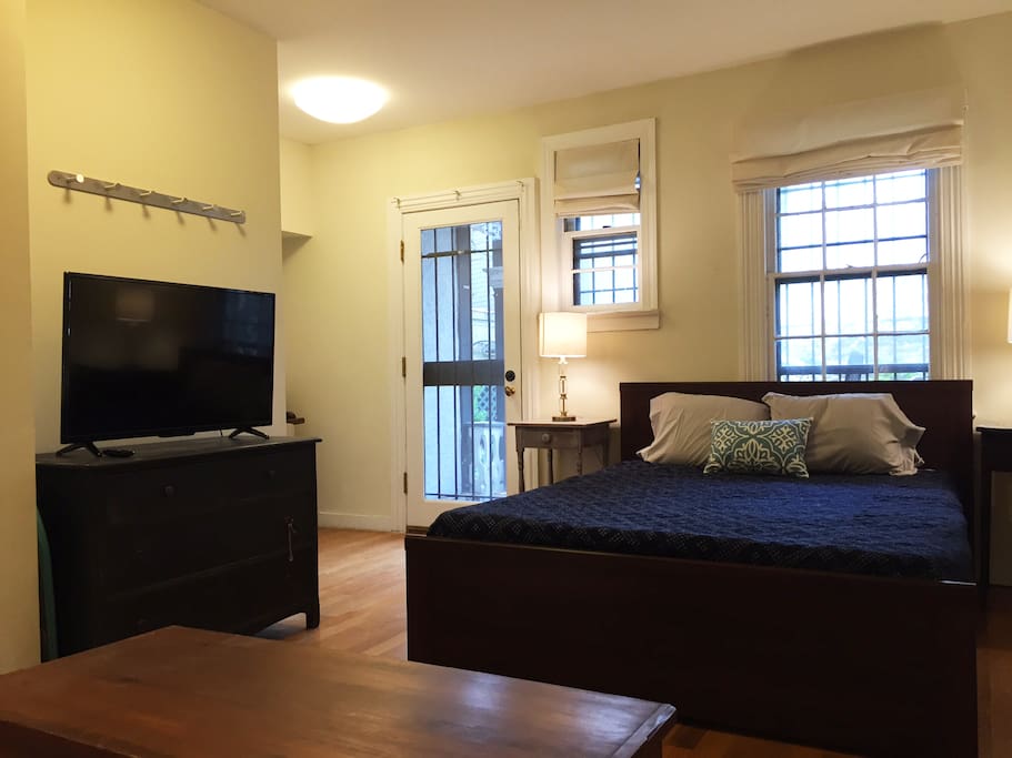 Spacious bedroom area with queen sized bed and HDTV
