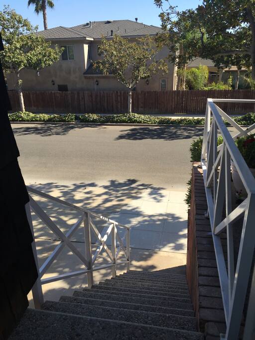 At top of entrance stairs with view of street.