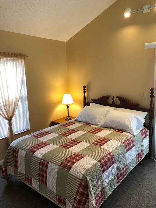 Master Bedroom has a queen bed and an attached half bathroom.