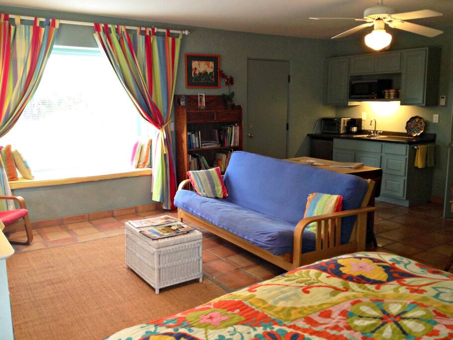 An extra futon/ couch bed and comfortable bay window onto private patio
