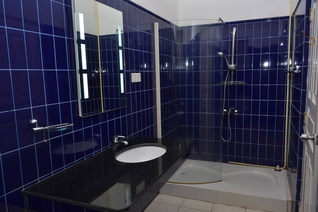 fully tiled shower- sink inlaid in marble pedestal