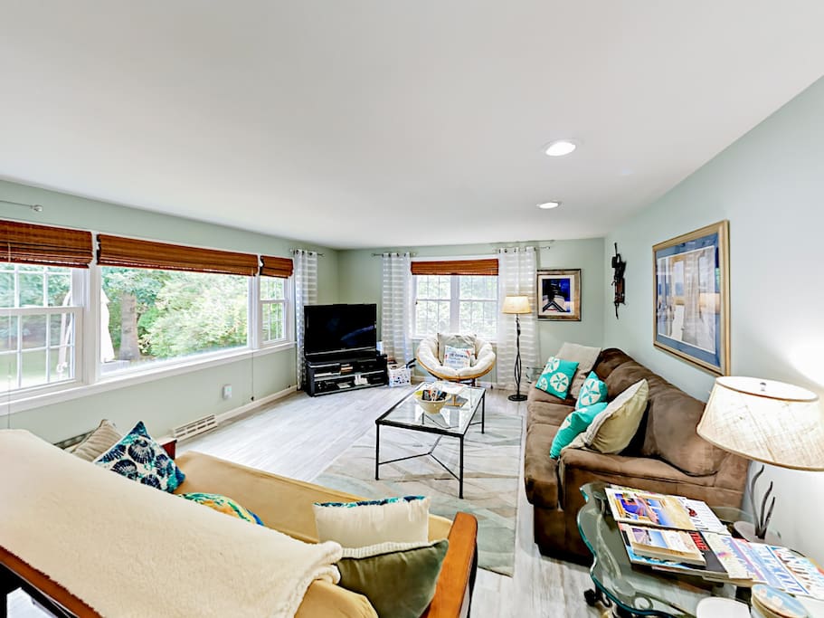 Lounge on 2 sofas and a chair in the open living room.