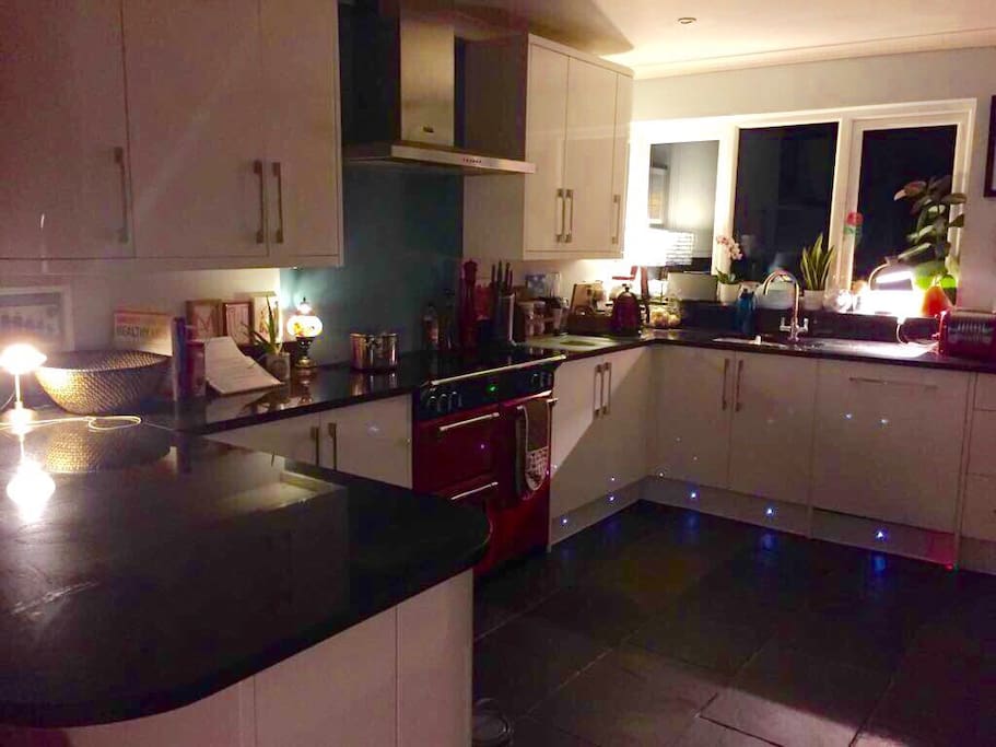 Open plan family kitchen with breakfast bar, range oven and American fridge/freezer