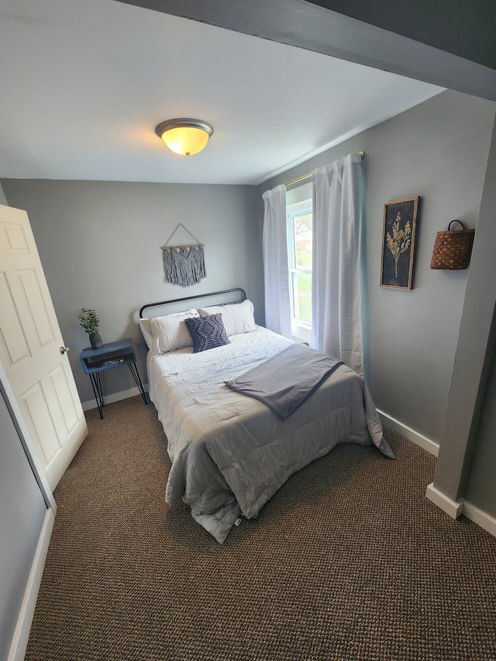 Smaller of the bedrooms, equipped with a full bed, closet space, chest of drawers and small TV. 