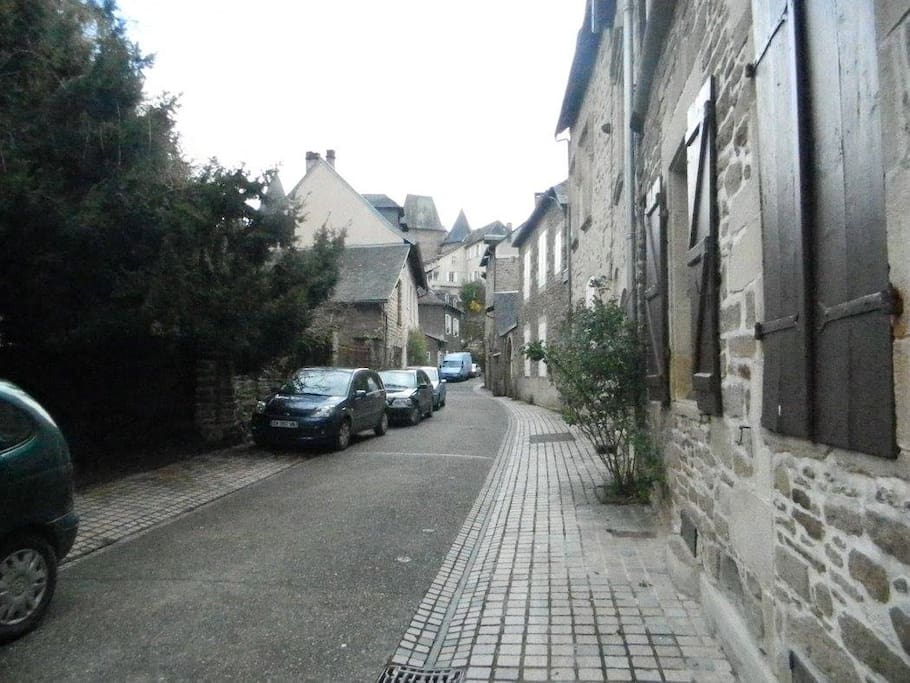 Street view facing up to the town square where there are 3 cafes for coffee and croissants.