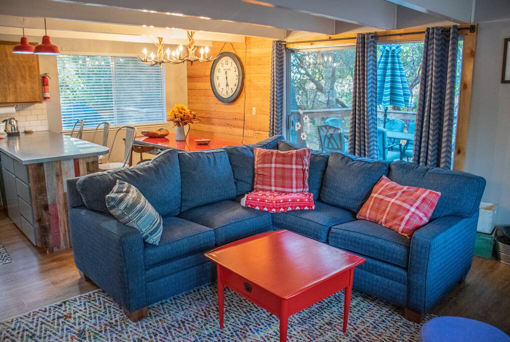 Living room with sofa, dining table and bar