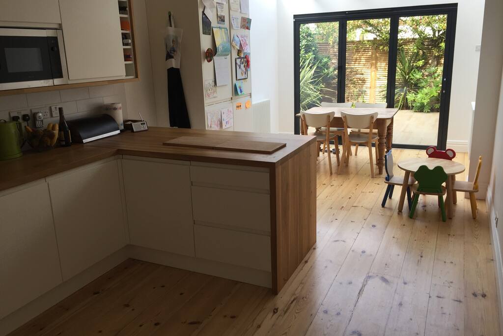 Kitchen / Dining area with bifold doors leading to patio garden
