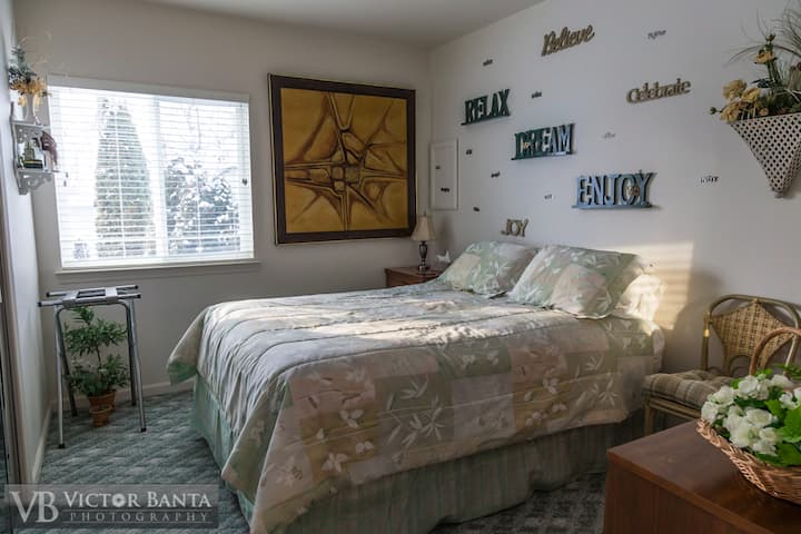 غرفة نوم بسرير بحجم كبير وخزانة ملابس وطاولة جانبية/طاولة وخزانة ملابس.