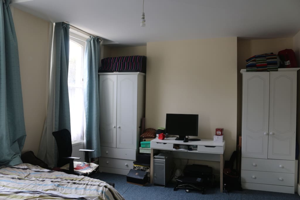Bedroom with large double bed and sash windows