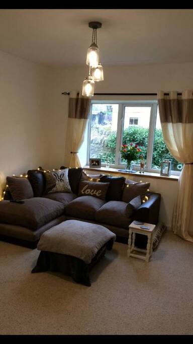 Lounge with log burning stove and large tv