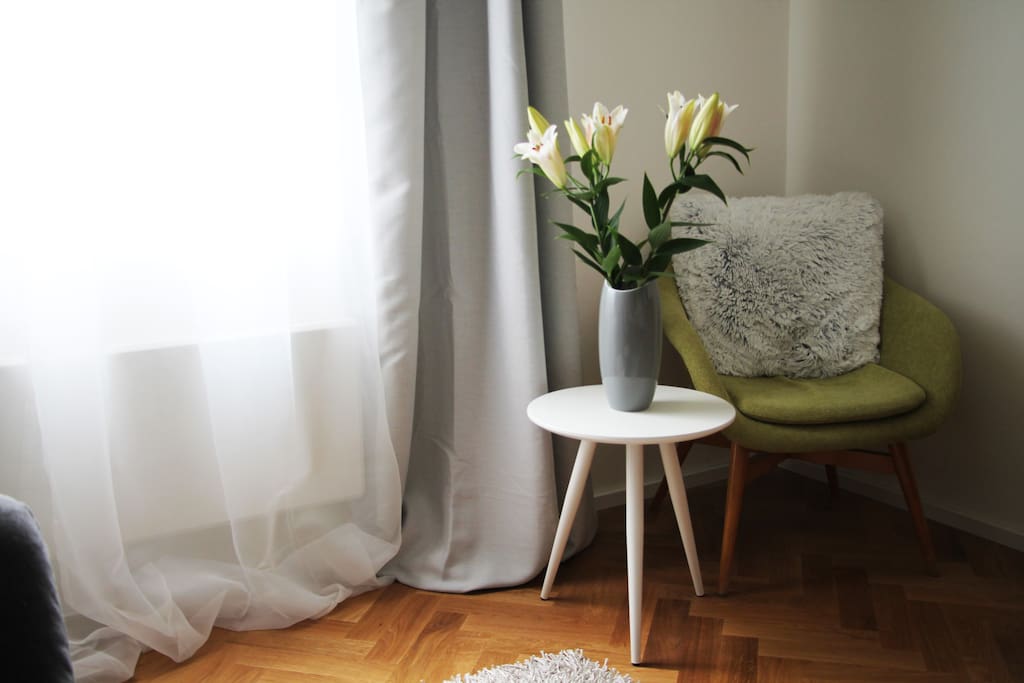 Warm reading corner next to the bright window.