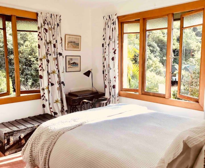 Our AirBnB bedroom with its super comfortable high bed to take advantage of the lovely bush views.