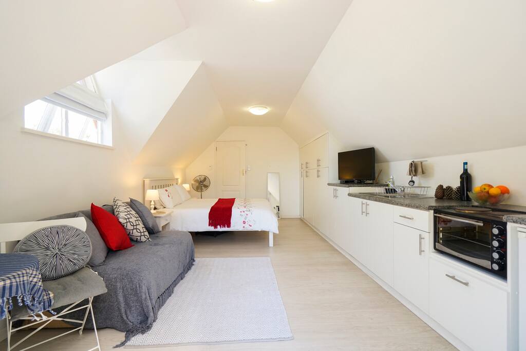 A space for laptops on the left and a full kitchenette on the right