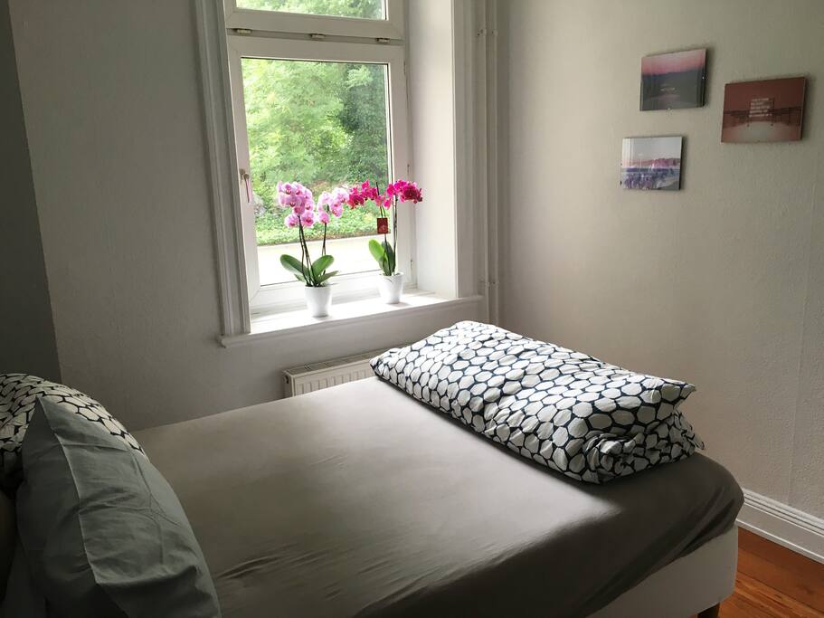 Light-filled bedroom with double bed.