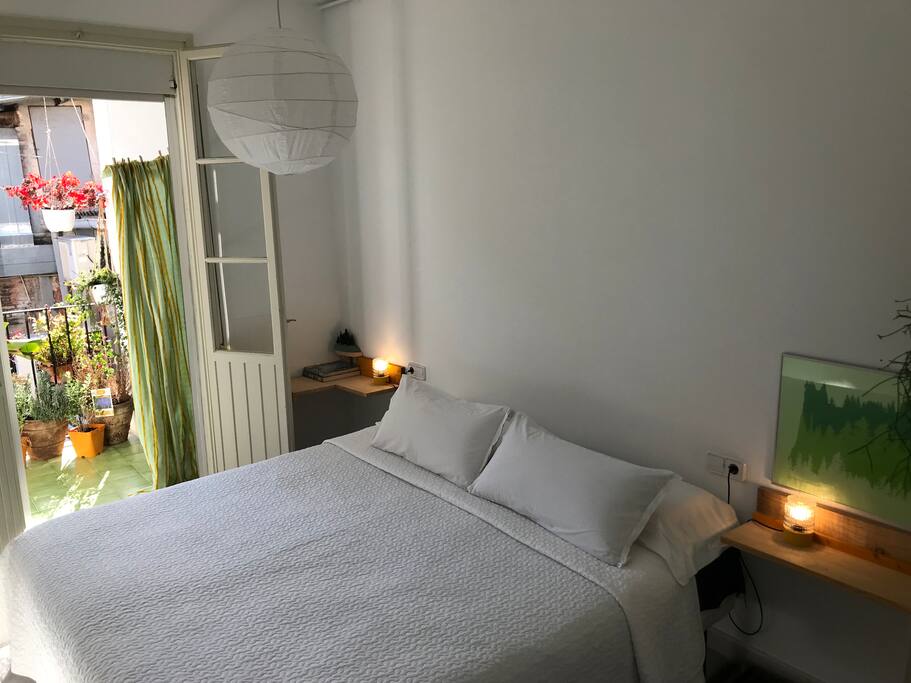 king size bed, with nice sheets and cover, sunny view.