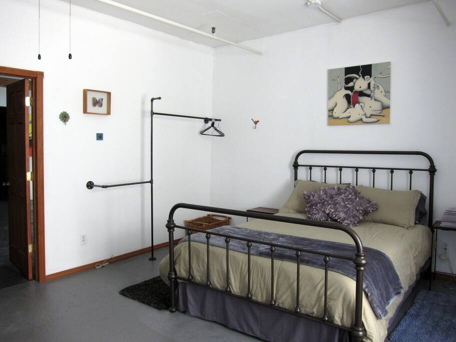 Room features an industrial pipe closet with plenty of room to organize your outfits and lots of cute hooks to hang smaller accessories.