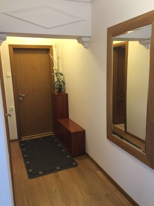 Entry hall with shoe storage at right. Also, clothes closet at left.