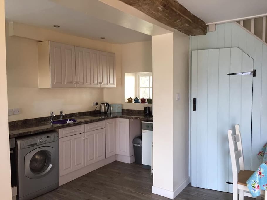 Fully fitted kitchen with washing machine.