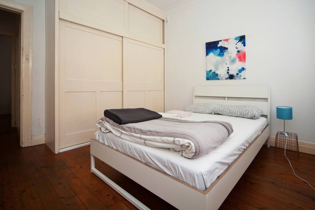 The master bed room with a double bed and build-in storage.