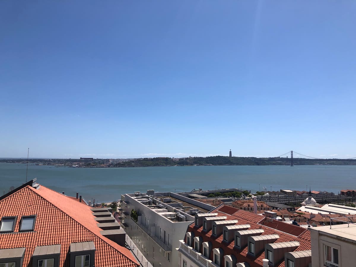 View over the Tagus river and Lisbon rooftops from the Lisbon Chiado One terrace