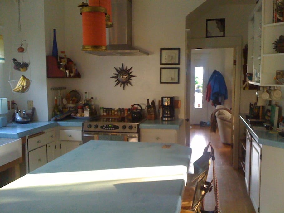 Kitchen - farmhouse sink, concrete counters, stainless steel appliances