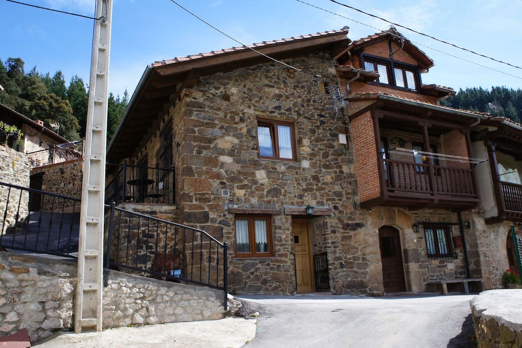 The house with the balcony on the left side