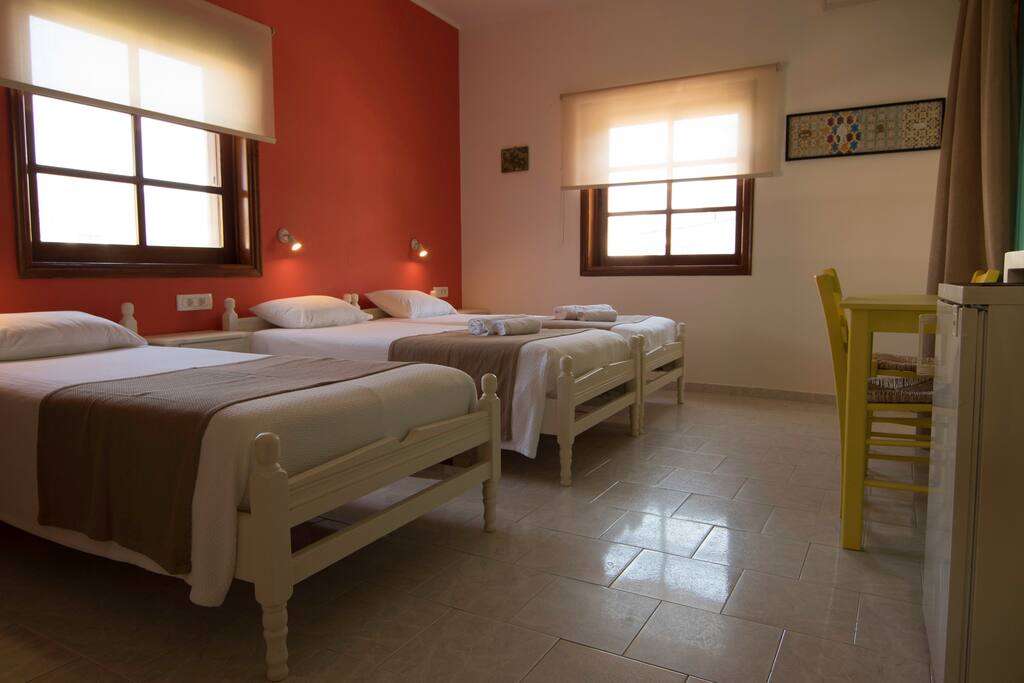The bright room has two large windows and a balcony