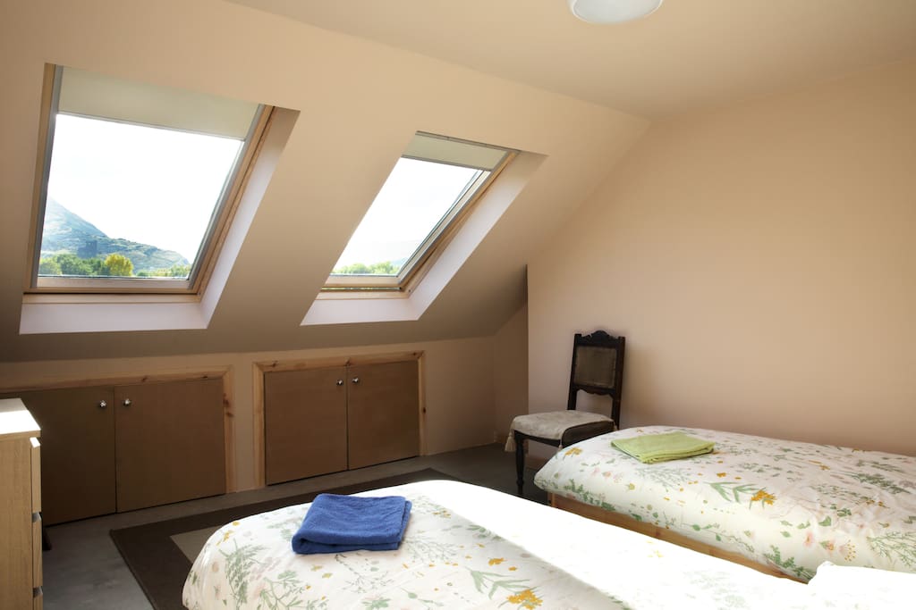 Front bedroom with large south-facing windows giving stunning views across Holyrood Park to Arthur's Seat